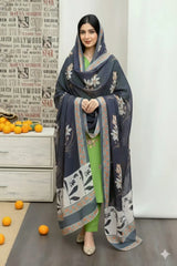 Woman wearing a dark blue embroidered dupatta over a green outfit, standing in front of a white wall with text.